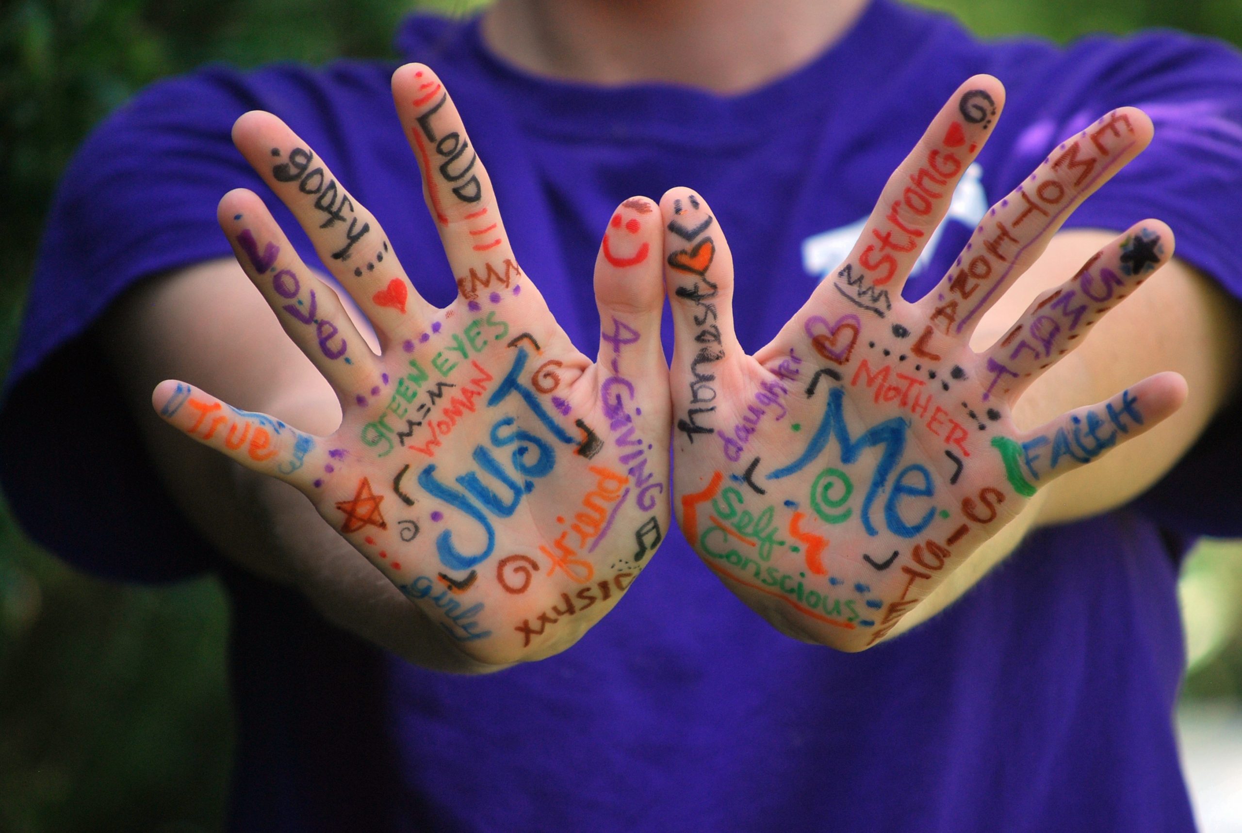 child with words written on hands